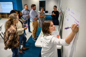 Angelica Carey of Innovate Memphis leads a group through a feedback exercise at Room In The Inn on March 4.